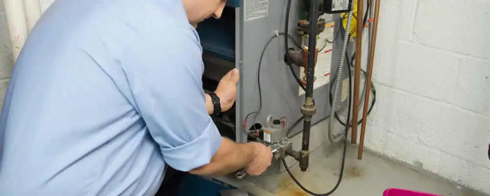 Furnace repair technician inspecting and servicing a home heating system in Charleston, SC