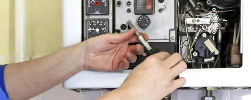 Heating repair technician adjusting boiler controls and components in Charleston, SC