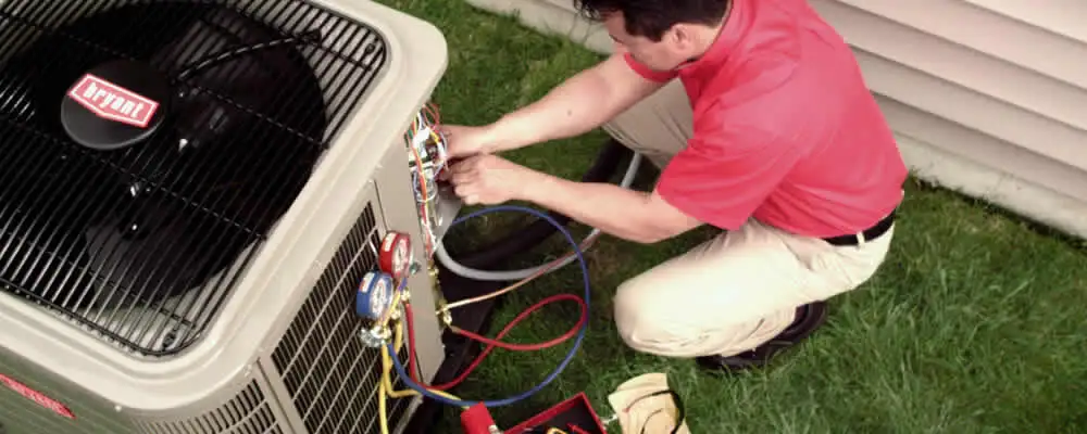 HVAC technician servicing an outdoor air conditioner unit in Charleston, SC